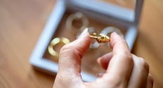 woman grabs gold ring out of jewelry box