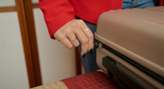 Hand moving the zipper on a suitcase