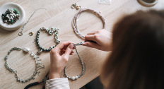 woman works on magnetic jewelry pieces 