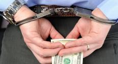 Handcuffed and holding money