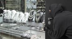 Masked robber outside showcase window-1