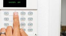 punching in a code on alarm keypad